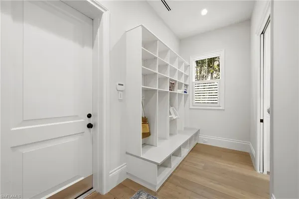 a view of wooden floor and windows in a room