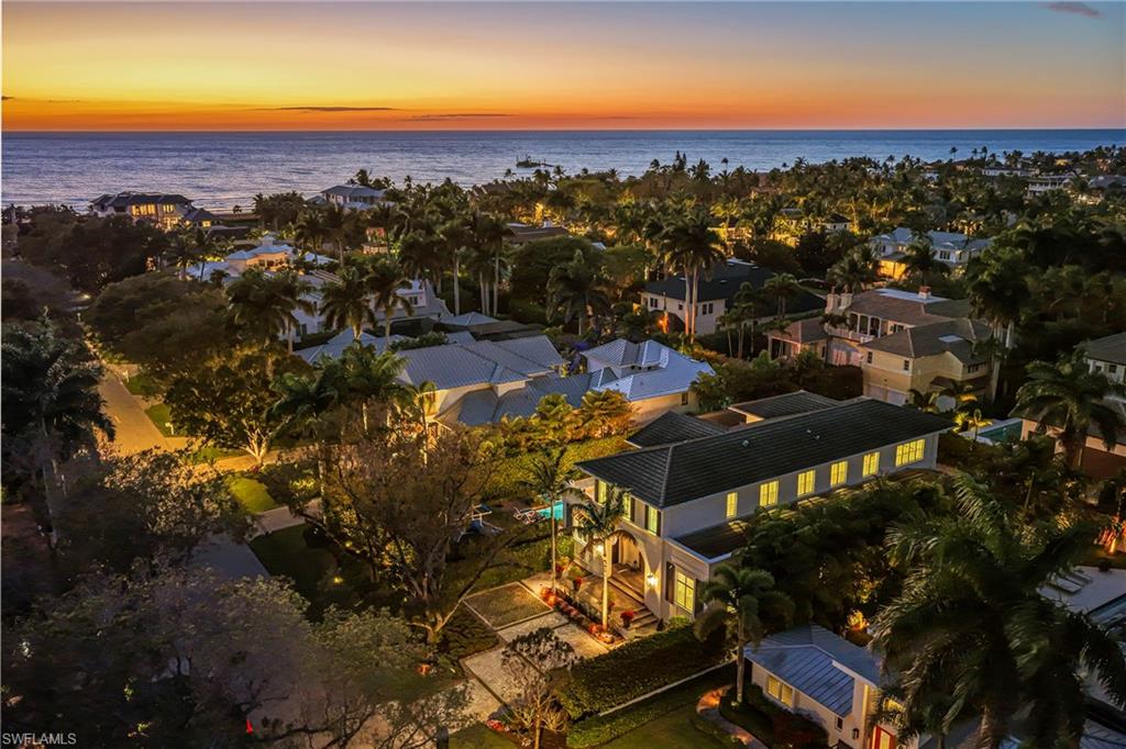 215 3rd Avenue North Naples, FL 34102 - Photo 2 of 47 Aerial view at dusk of a water view and a residential view