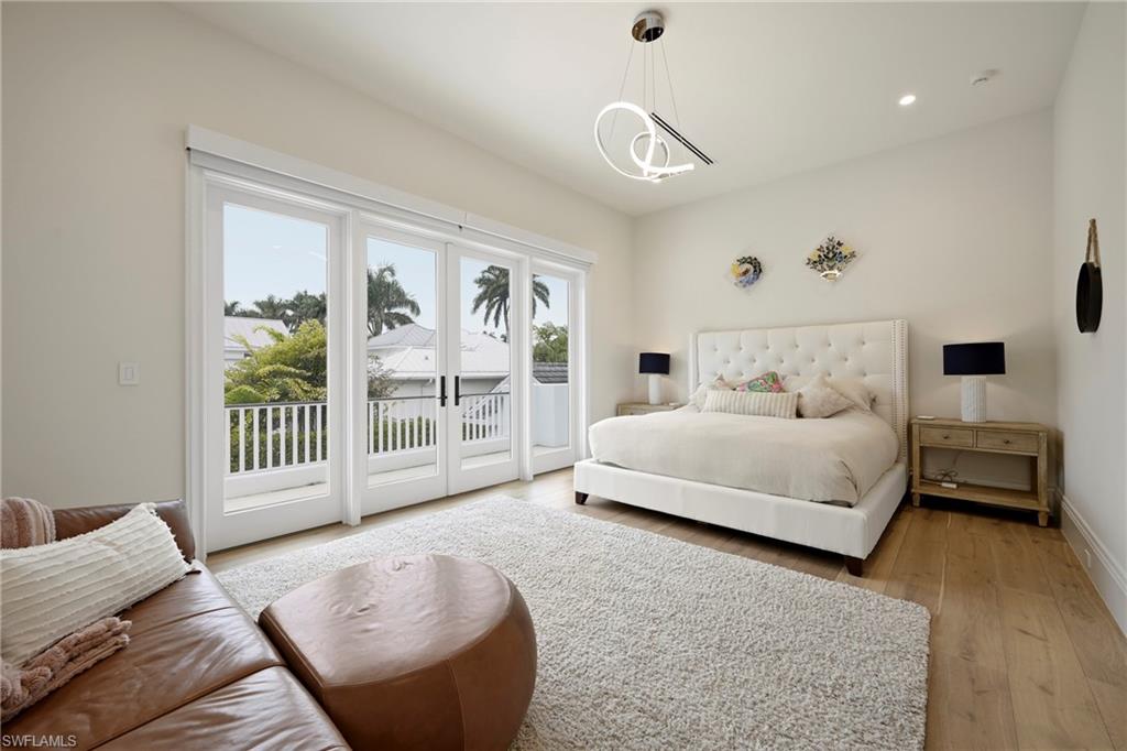 215 3rd Avenue North Naples, FL 34102 - Photo 31 of 47 Bedroom with light wood-type flooring, access to outside, french doors, and hanging lights