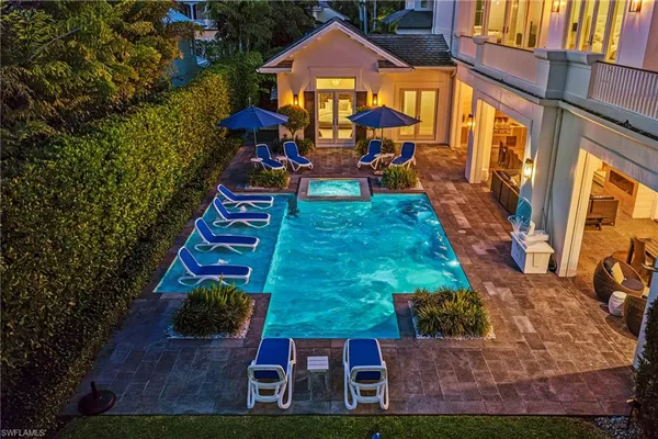 an aerial view of a house with a yard basket ball court and outdoor seating