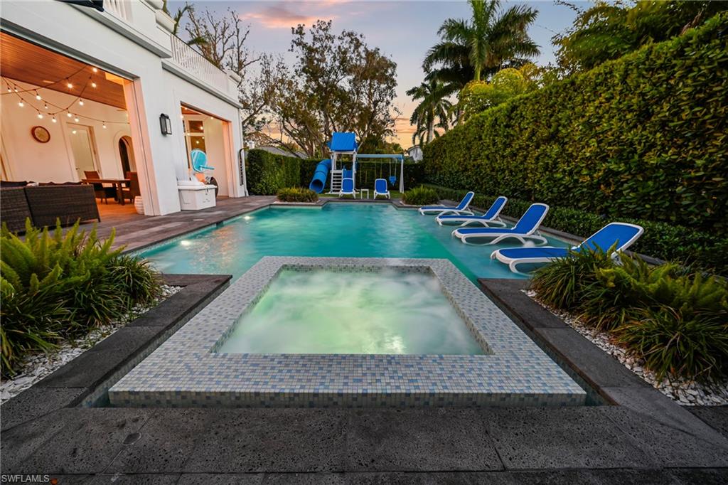 215 3rd Avenue North Naples, FL 34102 - Photo 41 of 47 View of pool with patio surround, an in-ground hot tub, and a fenced backyard