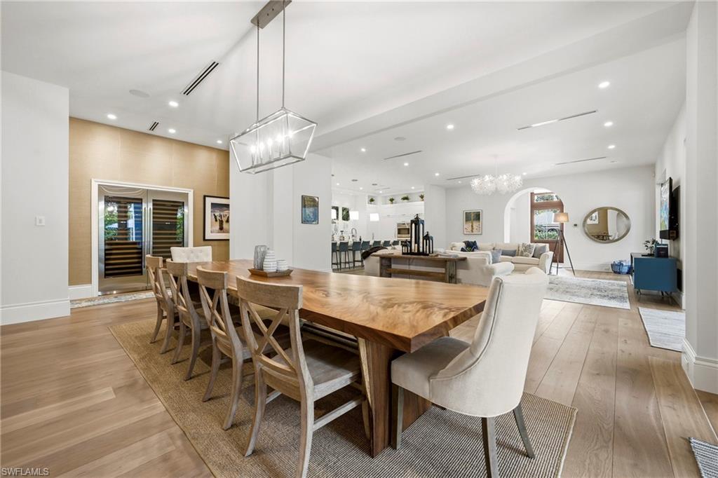 215 3rd Avenue North Naples, FL 34102 - Photo 8 of 47 Dining area featuring suspended lighting, light wood finished floors, and arched walkways