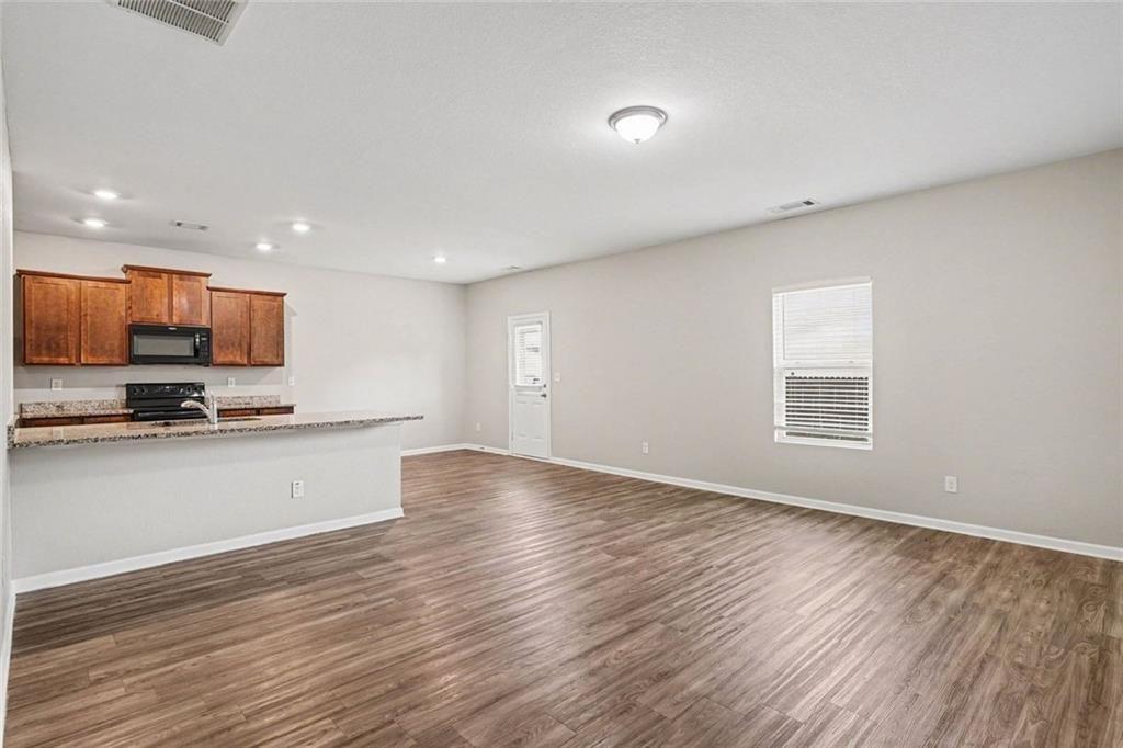 10941 Wheeler Trace Hampton, GA 30228 - Photo 4 of 21 a view of kitchen with sink and wooden floor