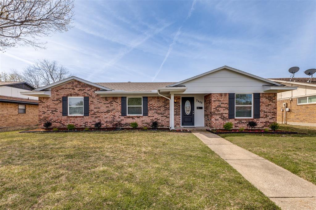 a front view of a house with a garden and yard