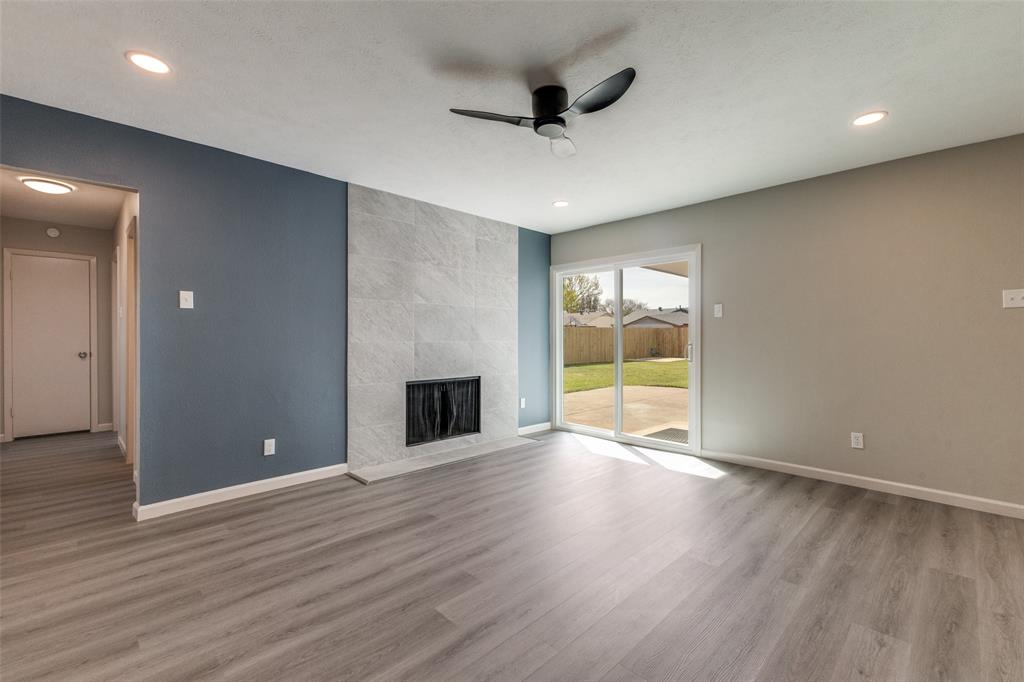 3406 Blue Ridge Lane Garland, TX 75042 - Photo 11 of 25 a view of an empty room with wooden floor and a window
