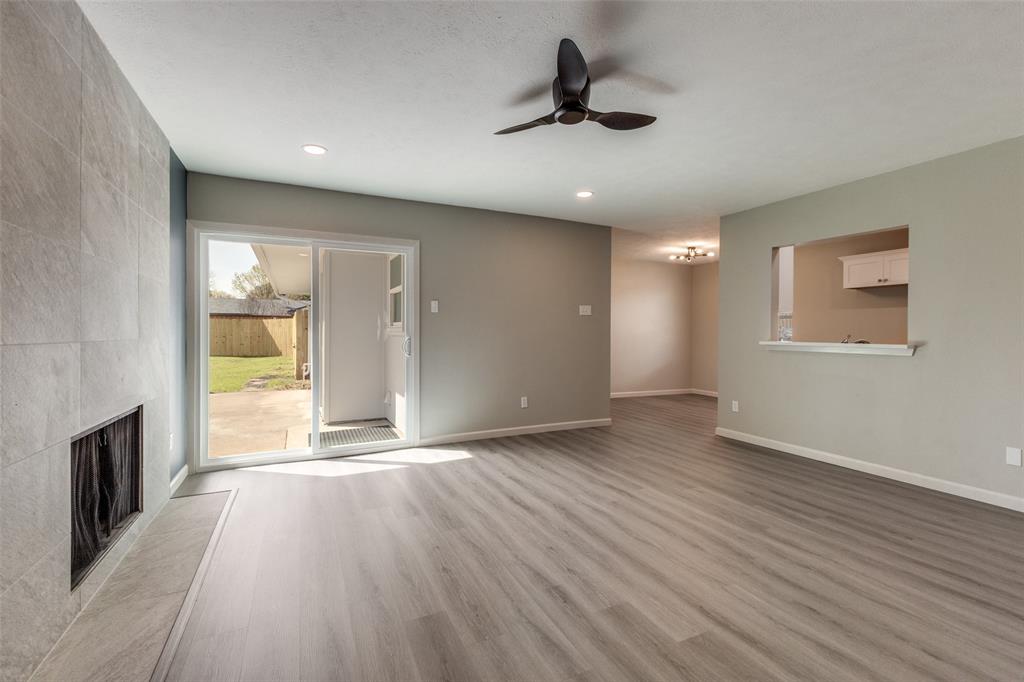 3406 Blue Ridge Lane Garland, TX 75042 - Photo 12 of 25 a view of empty room with wooden floor and fan