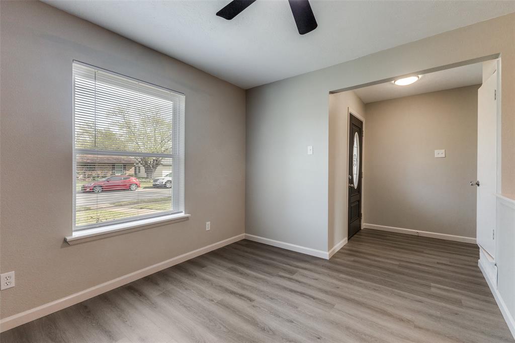 3406 Blue Ridge Lane Garland, TX 75042 - Photo 13 of 25 wooden floor in an empty room with a window