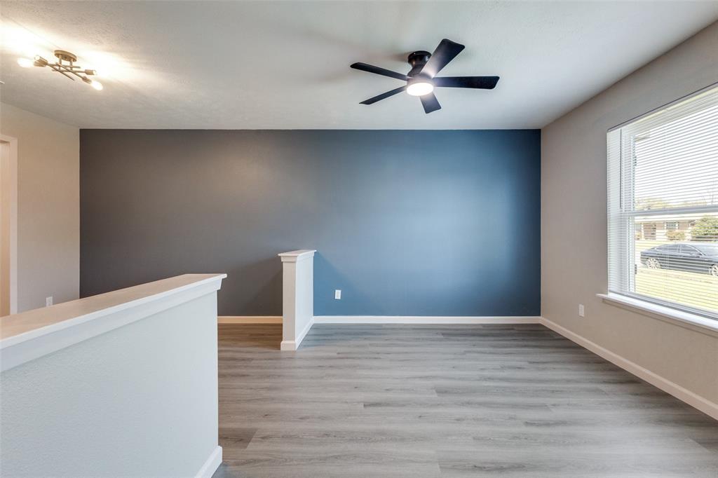 3406 Blue Ridge Lane Garland, TX 75042 - Photo 14 of 25 a view of an empty room with a window and wooden floor
