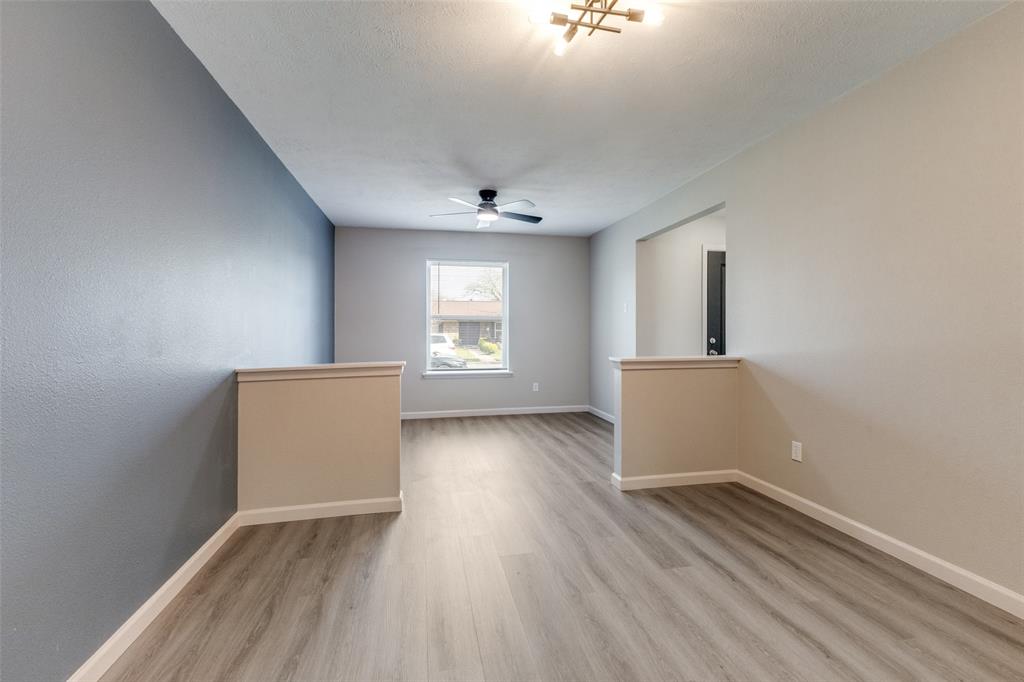 3406 Blue Ridge Lane Garland, TX 75042 - Photo 15 of 25 wooden floor in an empty room with a window