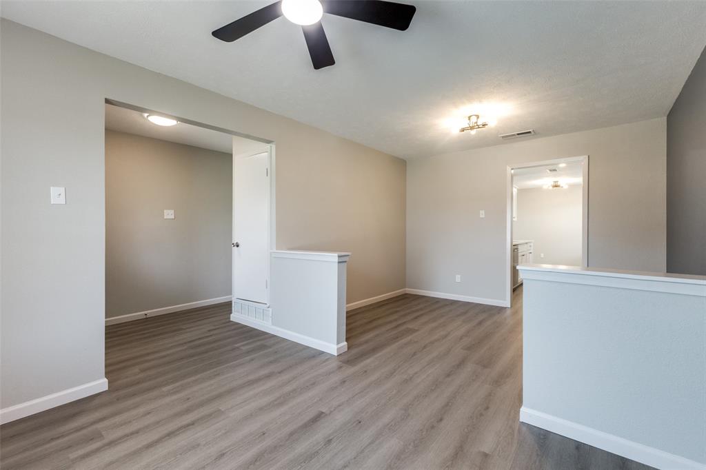 3406 Blue Ridge Lane Garland, TX 75042 - Photo 16 of 25 an empty room with wooden floor and windows