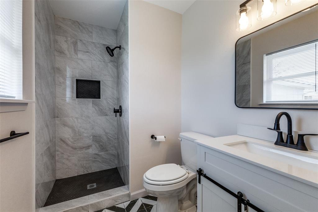 3406 Blue Ridge Lane Garland, TX 75042 - Photo 18 of 25 a bathroom with a sink toilet and shower