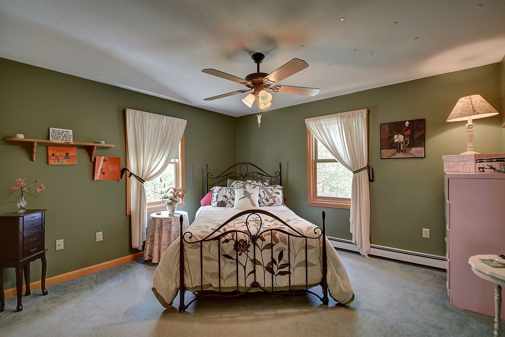 126 Wales Road Holland, MA 01521 - Photo 18 of 24 a bedroom with a bed and a chandelier