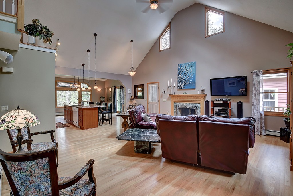 126 Wales Road Holland, MA 01521 - Photo 19 of 24 a living room with fireplace furniture and a wooden floor