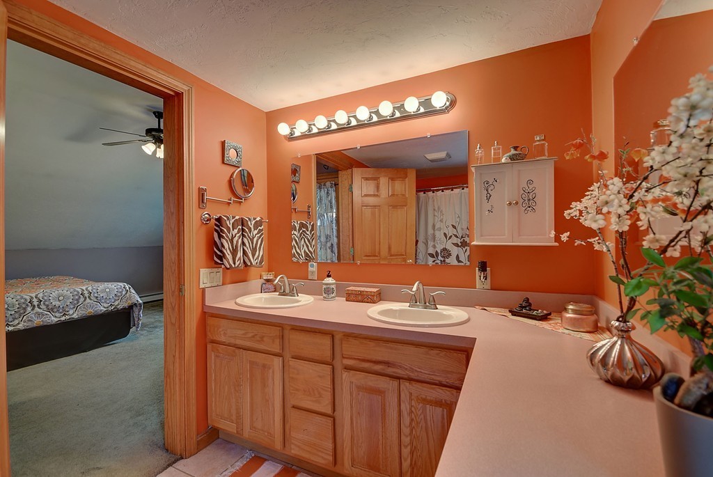 126 Wales Road Holland, MA 01521 - Photo 22 of 24 a en suite bathroom with a granite countertop sink and a mirror