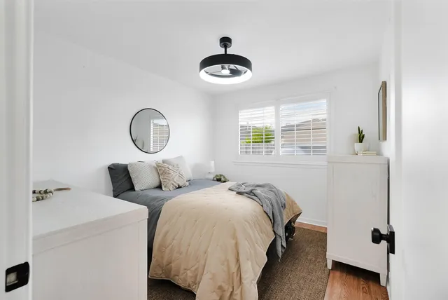 a bedroom with bed and a window