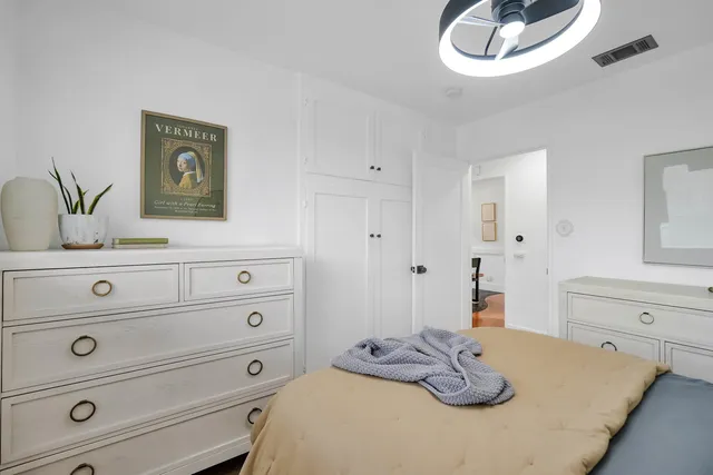 a bedroom with a bed and a dresser