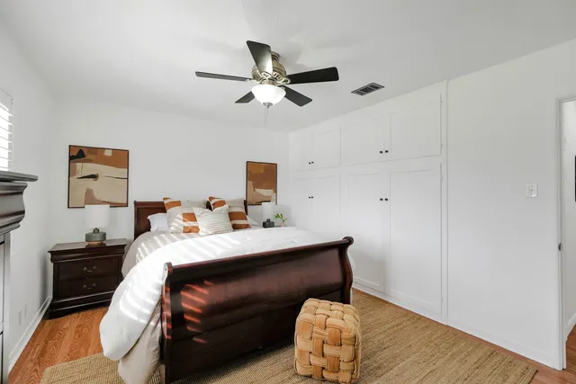 a bedroom with a bed and wooden floor