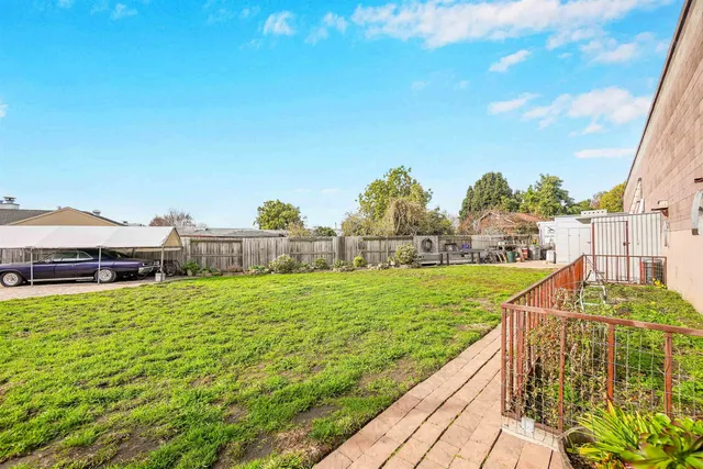 a view of a swimming pool with a garden and deck