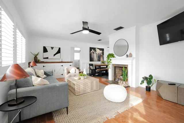 a living room with furniture a fireplace and a flat screen tv