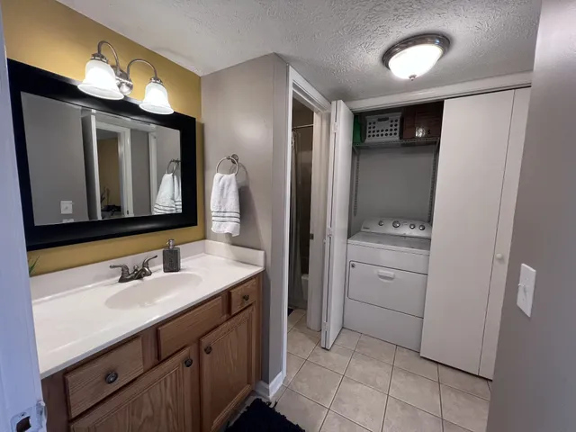 a bathroom with a double vanity sink mirror and toilet