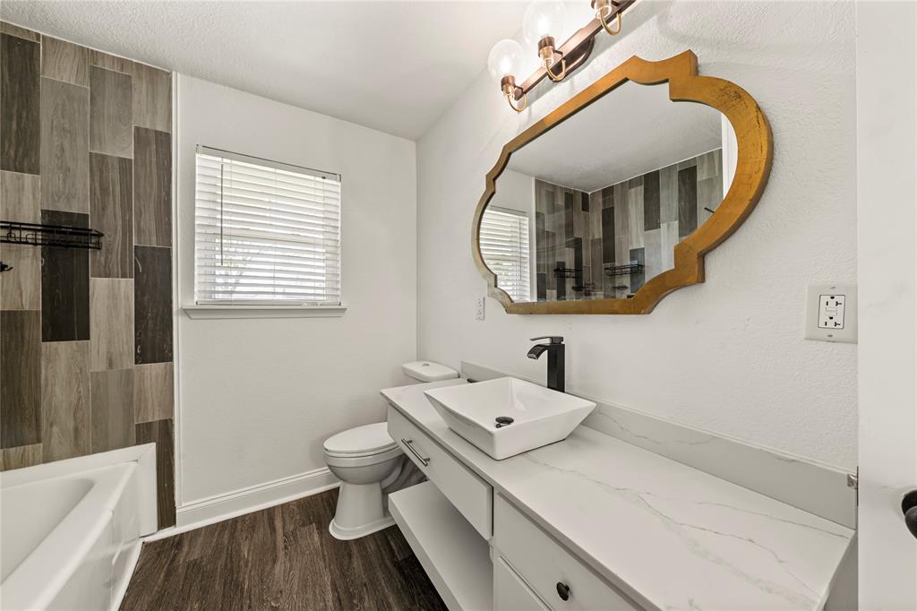 104 East Santa Anna Street Robinson, TX 76706 - Photo 31 of 36 a bathroom with a sink and a mirror