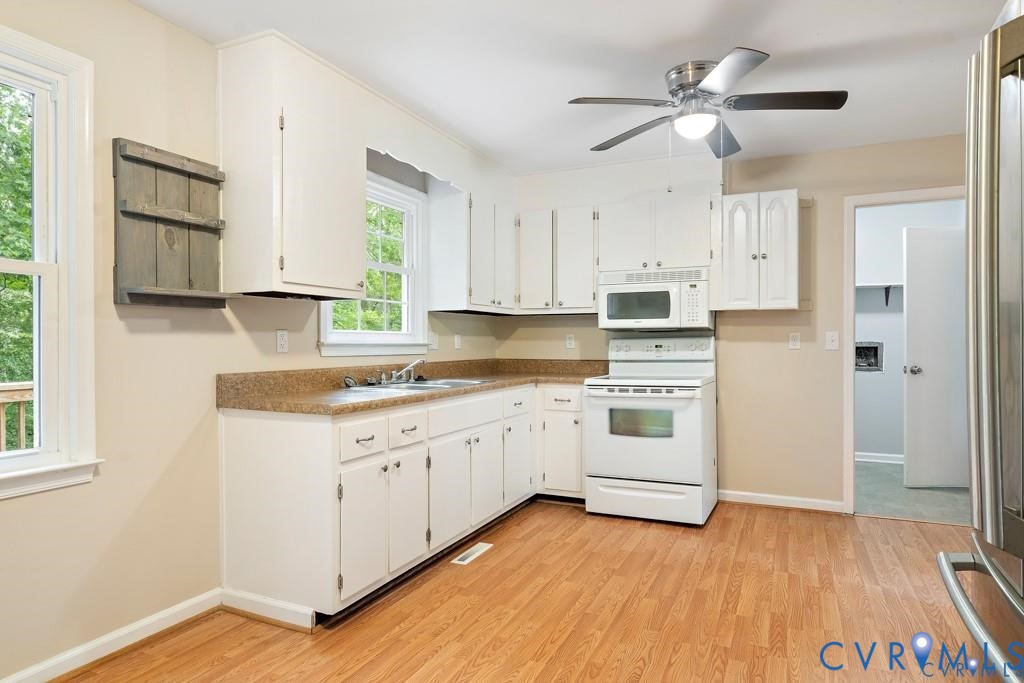4001 London Road Hopewell, VA 23860 - Photo 5 of 8 a kitchen with granite countertop white cabinets and white appliances