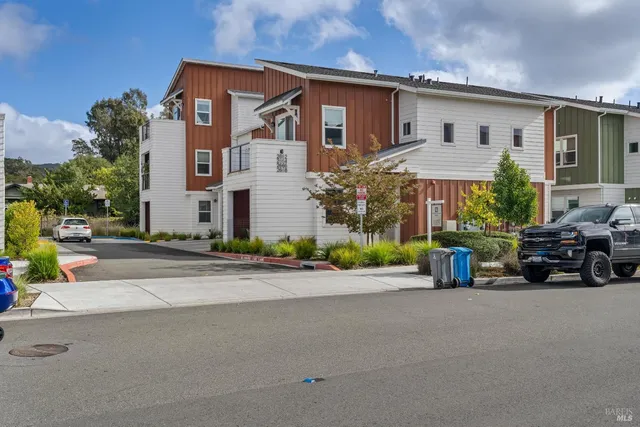 front view of a house with a cars park next to a road
