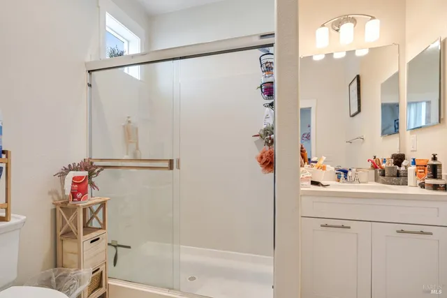 a bathroom with a sink mirror vanity and toilet