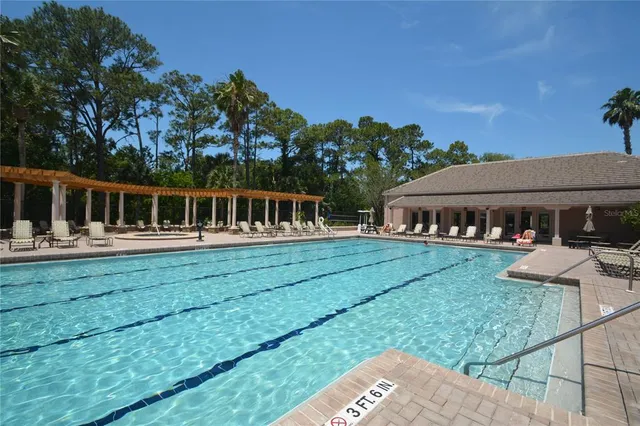 a swimming pool with view of lake in the background