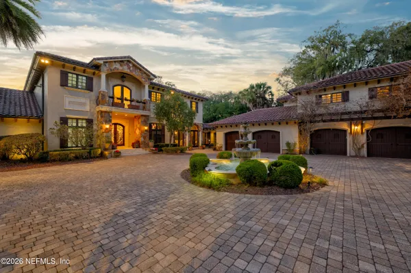 a front view of a house with a garden and yard