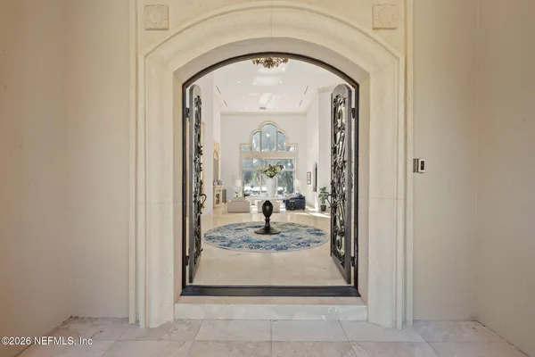 a dining room with furniture a rug and a chandelier