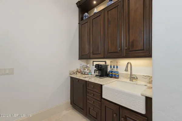 a bathroom with a granite countertop sink a mirror and a shower