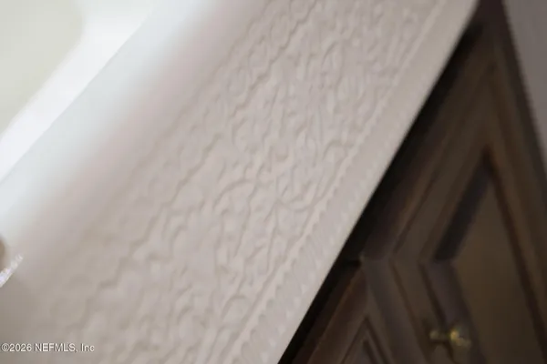 a view of a garden with a lot of flower plants and wooden fence