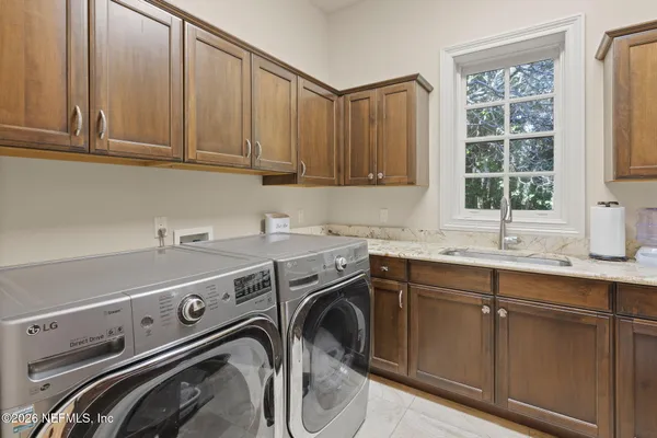 a bathroom with a double vanity sink and mirror with shower