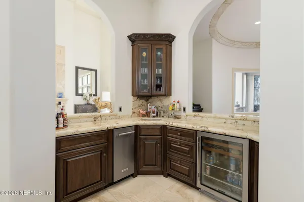 a living room with stainless steel appliances granite countertop furniture and a living room