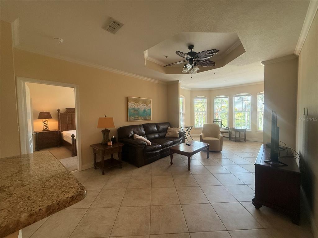 2715 Via Capri, Unit 732 Clearwater, FL 33764 - Photo 11 of 31 a living room with furniture and a large mirror