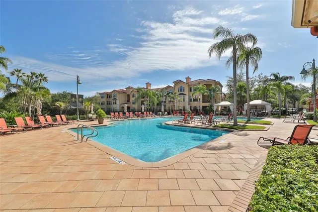 a view of a swimming pool and lounge chairs