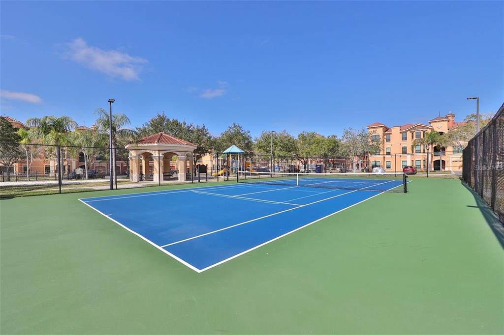 2715 Via Capri, Unit 732 Clearwater, FL 33764 - Photo 21 of 31 a view of tennis court with chairs