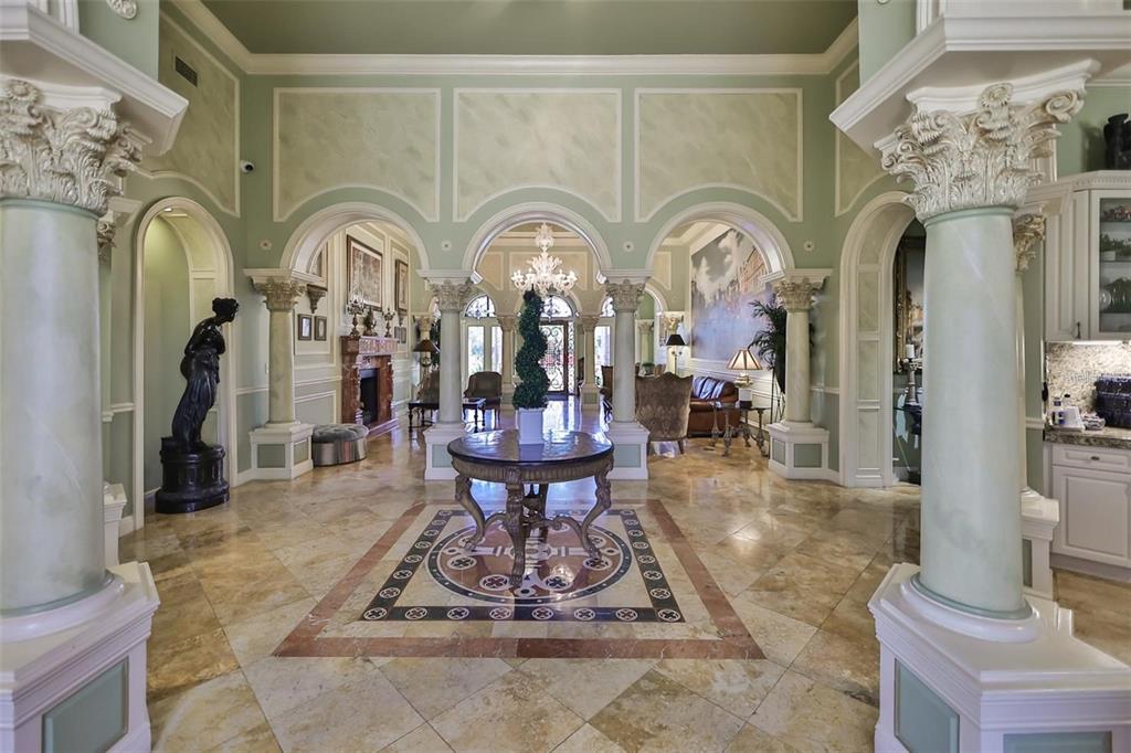 2715 Via Capri, Unit 732 Clearwater, FL 33764 - Photo 22 of 31 a living room with fireplace chandelier and a rug