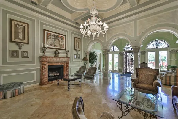 a living room with fireplace furniture and a chandelier