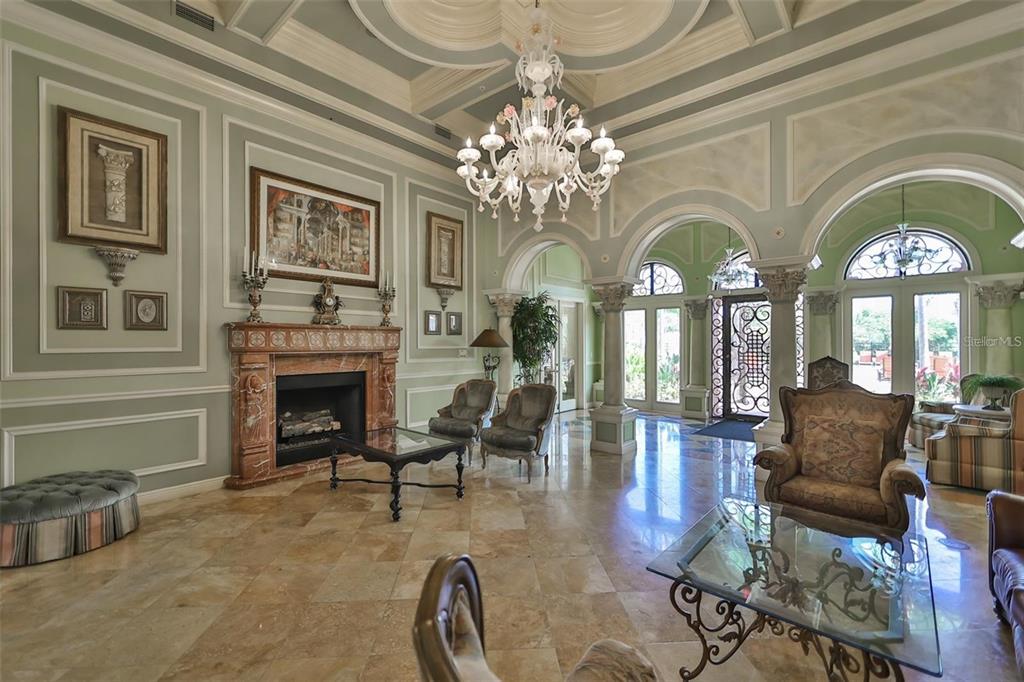 2715 Via Capri, Unit 732 Clearwater, FL 33764 - Photo 23 of 31 a living room with fireplace furniture and a chandelier