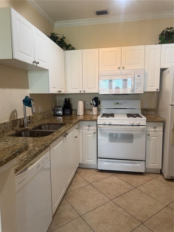 2715 Via Capri, Unit 732 Clearwater, FL 33764 - Photo 8 of 31 a kitchen with cabinets appliances a sink and a counter top space