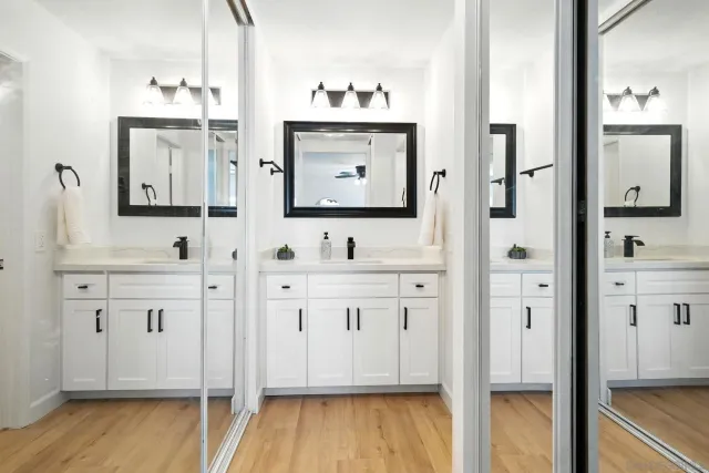 a bathroom with double vanity sink and mirror