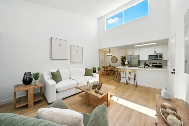 a living room with furniture and kitchen view