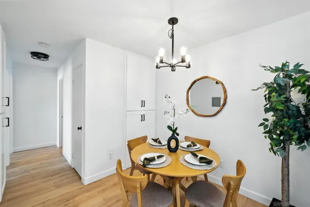 a view of a dining room with furniture and chandelier