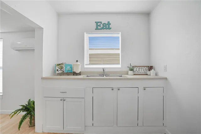 a bathroom with a granite countertop sink a mirror and a window