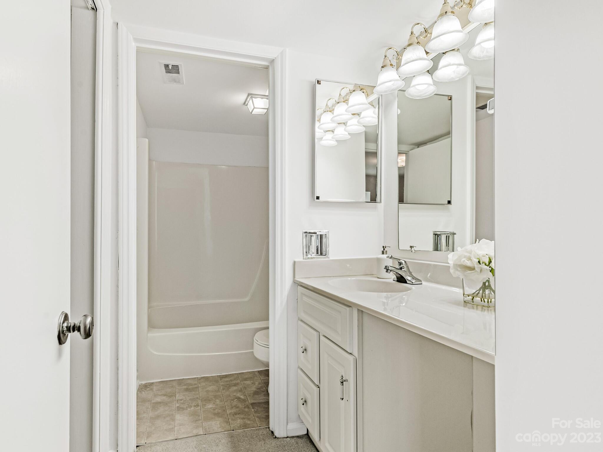 2227 Rexford Road, Unit B Charlotte, NC 28211 - Photo 13 of 23 a bathroom with a sink vanity tub and shower