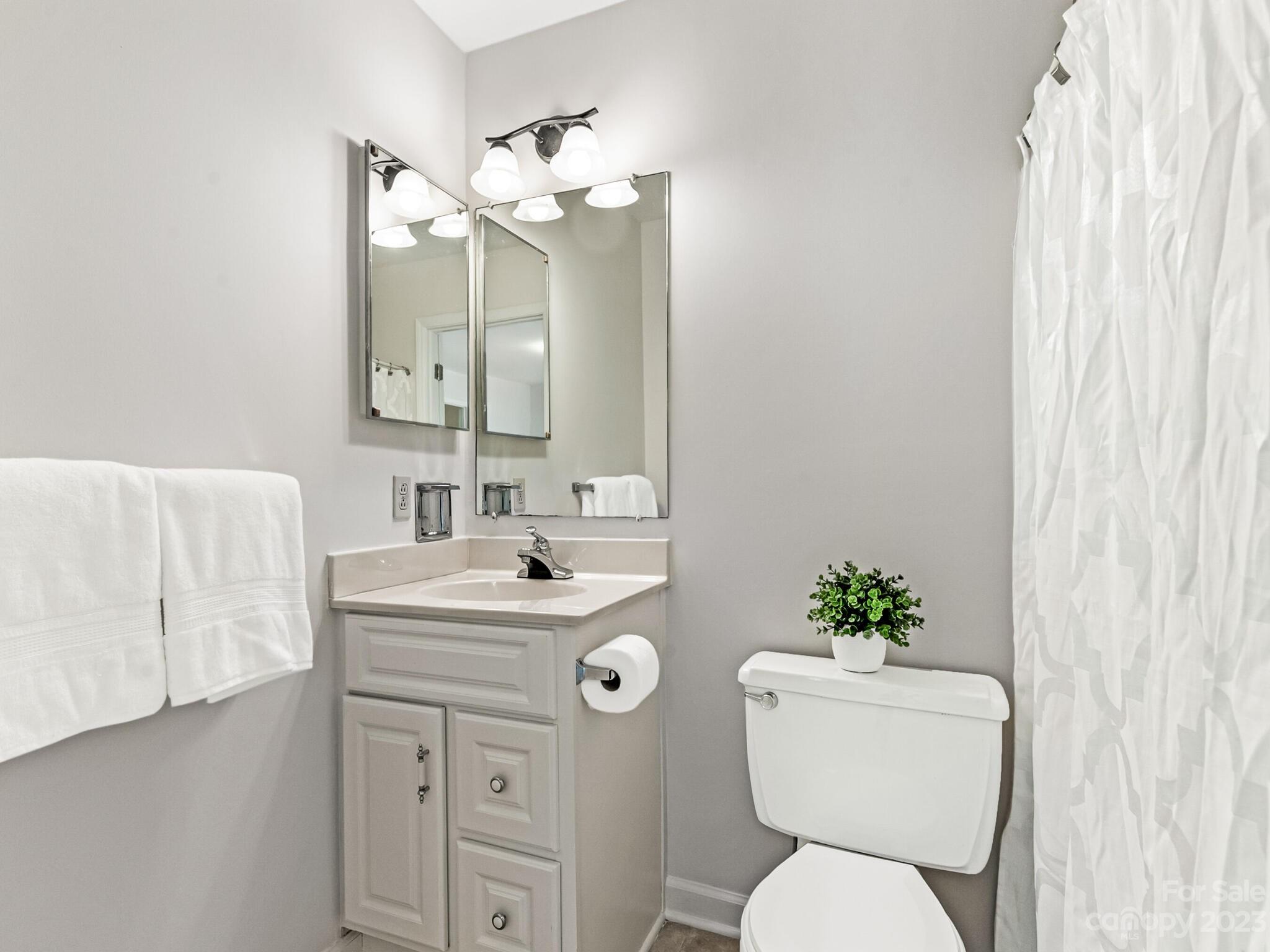 2227 Rexford Road, Unit B Charlotte, NC 28211 - Photo 16 of 23 a bathroom with a toilet sink and mirror