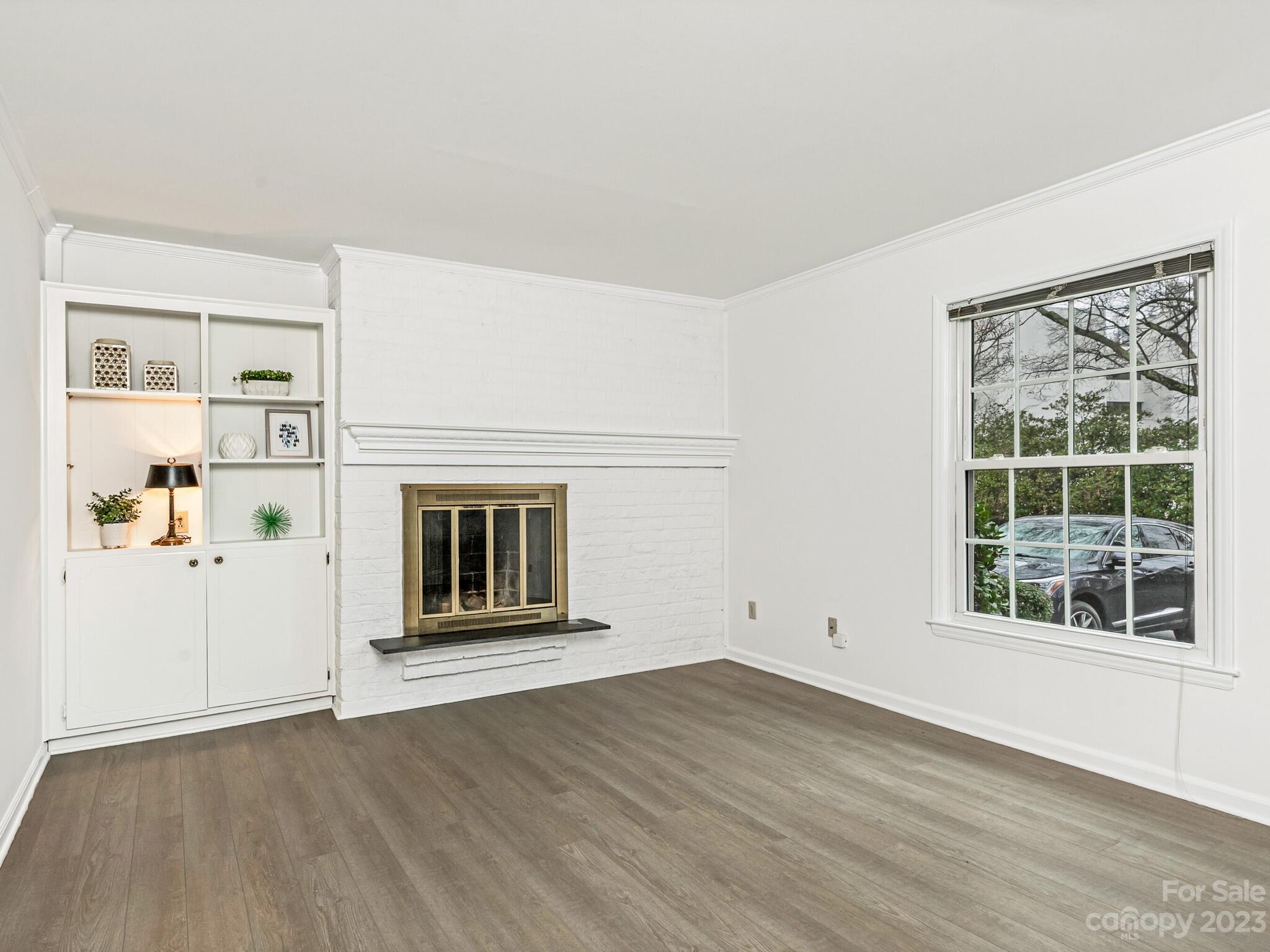 2227 Rexford Road, Unit B Charlotte, NC 28211 - Photo 4 of 23 an empty room with wooden floor and windows
