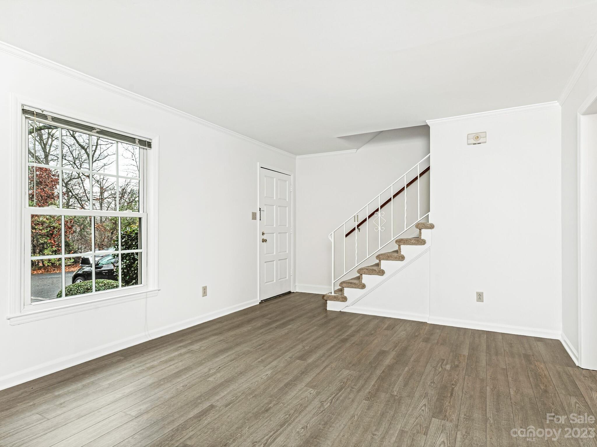 2227 Rexford Road, Unit B Charlotte, NC 28211 - Photo 5 of 23 a view of empty room with wooden floor and fan